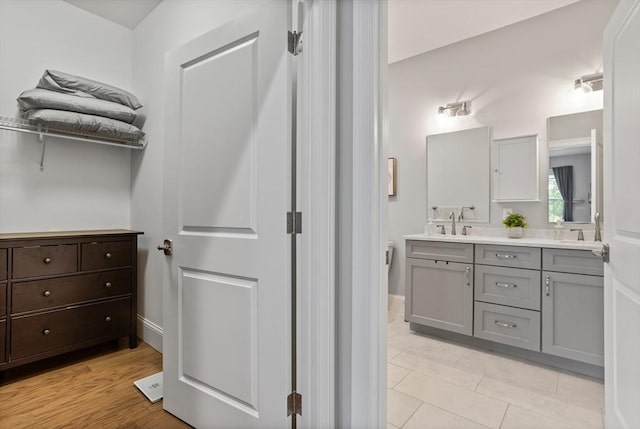 8 Sanborn St Unit 2012, Reading, MA 01867 - full bath featuring double vanity, baseboards, and tile patterned flooring