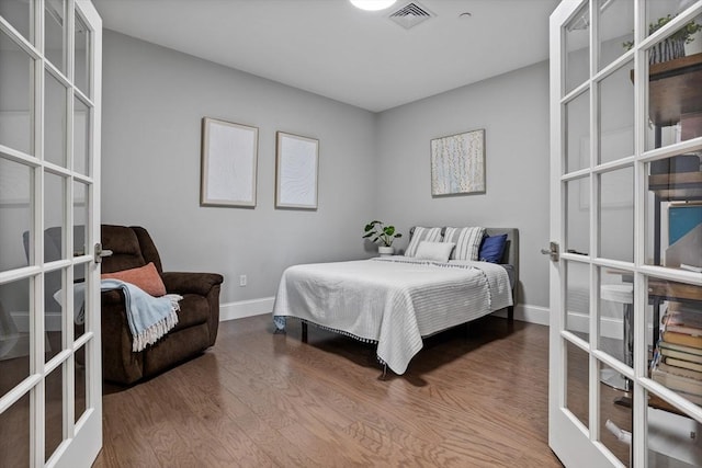 8 Sanborn St Unit 2012, Reading, MA 01867 - bedroom featuring french doors, baseboards, and wood finished floors