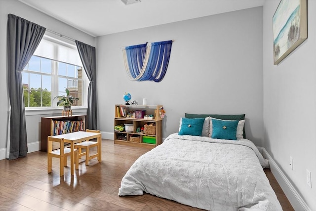 8 Sanborn St Unit 2012, Reading, MA 01867 - bedroom featuring baseboards and wood finished floors