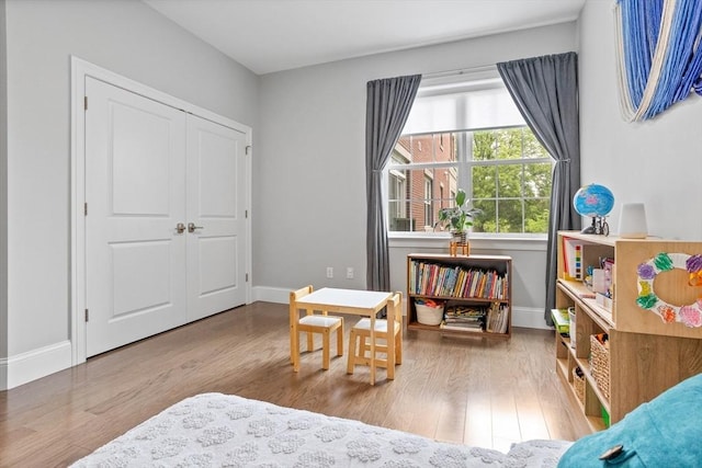 8 Sanborn St Unit 2012, Reading, MA 01867 - bedroom with wood finished floors, baseboards, and a closet