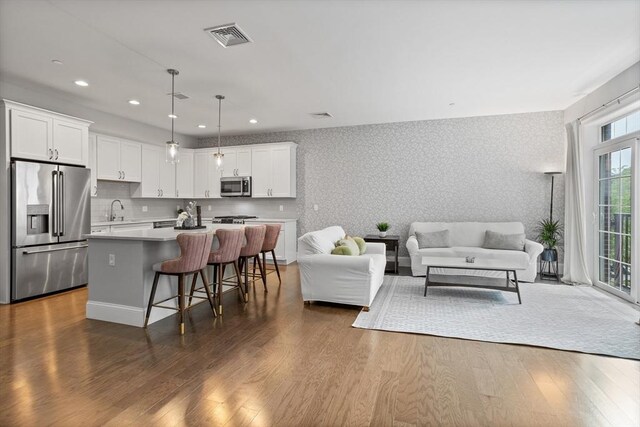 8 Sanborn St Unit 2012, Reading, MA 01867 - living area featuring wallpapered walls, dark wood finished floors, and recessed lighting
