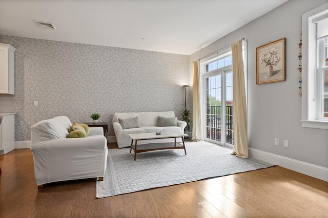 8 Sanborn St Unit 2012, Reading, MA 01867 - living room featuring wallpapered walls, healthy amount of natural light, baseboards, and wood finished floors