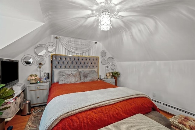 bedroom with baseboard heating, vaulted ceiling, and wood finished floors