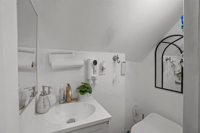 half bathroom featuring vanity and toilet