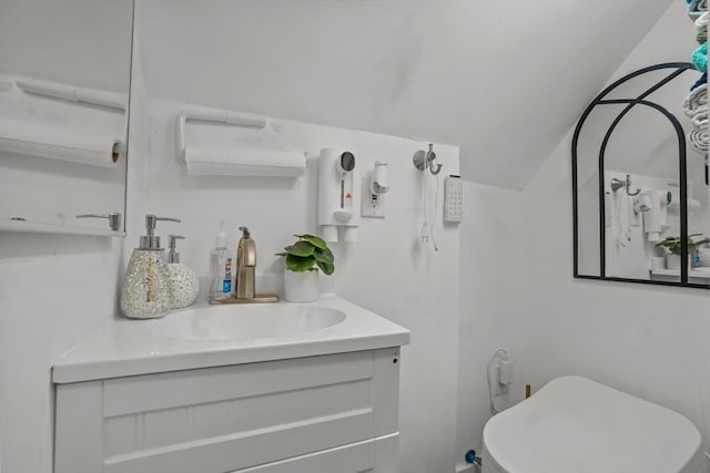 bathroom featuring lofted ceiling and vanity