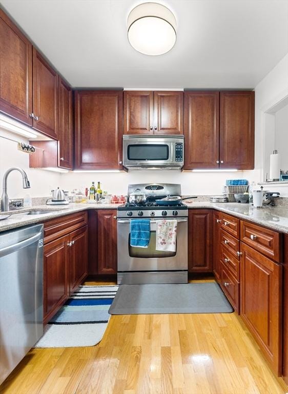 318 Rindge Ave Unit 411, Cambridge, MA 02140 - kitchen with appliances with stainless steel finishes, light countertops, and light wood-type flooring