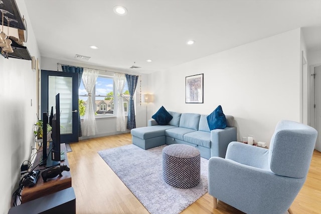 318 Rindge Ave Unit 411, Cambridge, MA 02140 - living area with light wood-style floors and recessed lighting