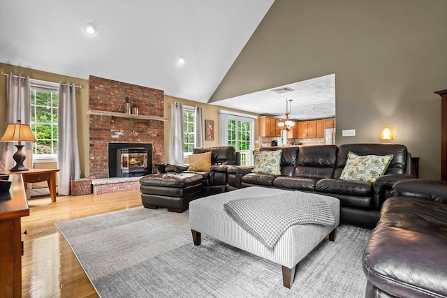 15 Hillside St, Rowley, MA 01969 - living room featuring plenty of natural light, light wood-style floors, a fireplace, recessed lighting, and a chandelier