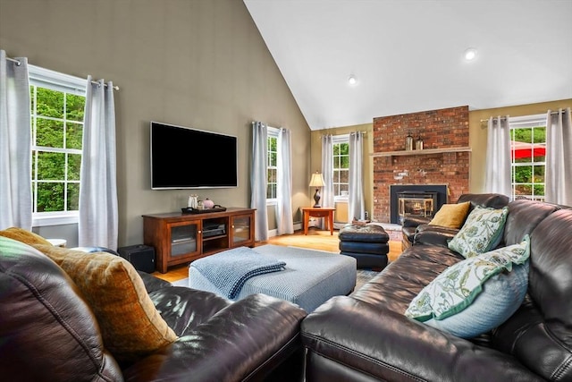 15 Hillside St, Rowley, MA 01969 - living room featuring high vaulted ceiling, plenty of natural light, wood finished floors, a fireplace, and recessed lighting