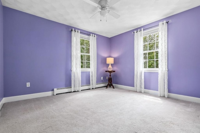 15 Hillside St, Rowley, MA 01969 - spare room featuring baseboard heating, healthy amount of natural light, a ceiling fan, and carpet