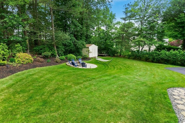 15 Hillside St, Rowley, MA 01969 - view of grassy yard with a fire pit and a storage unit