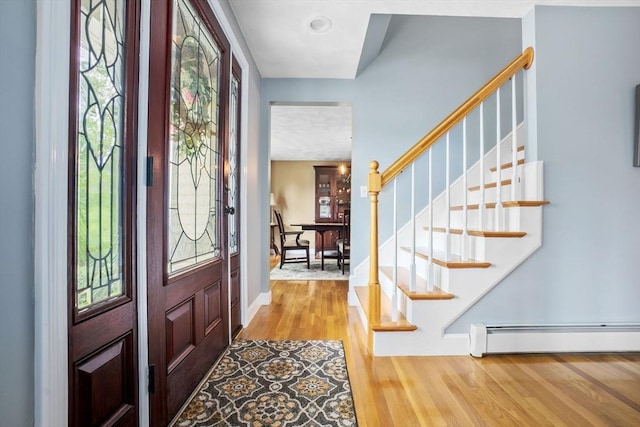 15 Hillside St, Rowley, MA 01969 - foyer with a baseboard radiator, wood finished floors, and stairs