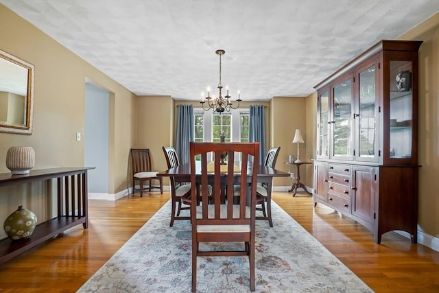 15 Hillside St, Rowley, MA 01969 - dining room with a chandelier, light wood-style flooring, and a textured ceiling