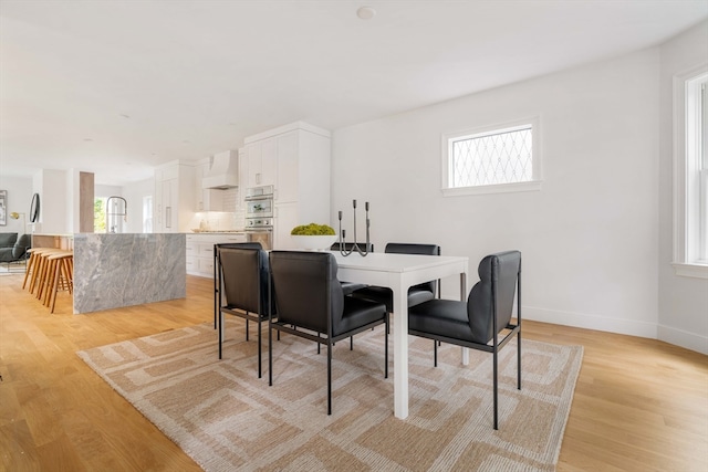 dining area with light wood-type flooring