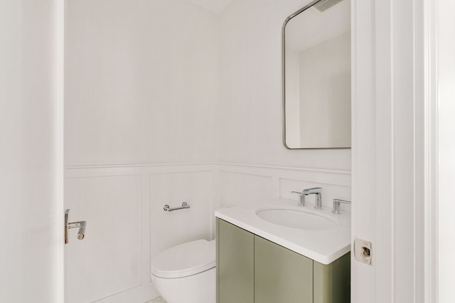 bathroom featuring vanity and toilet