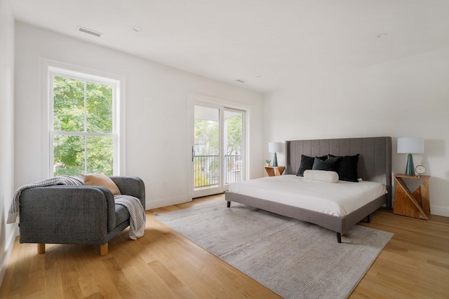 bedroom featuring access to outside and light wood-type flooring