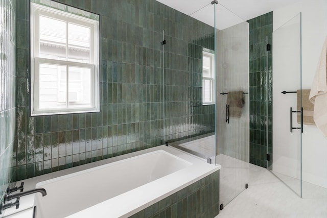 bathroom with plus walk in shower, tile walls, and tile patterned floors