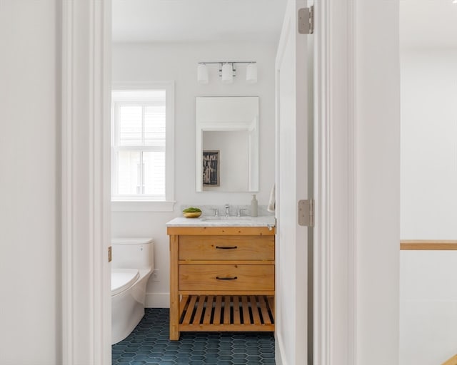 bathroom with tile patterned floors, vanity, and toilet