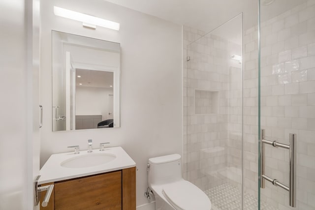 bathroom featuring vanity, toilet, and an enclosed shower