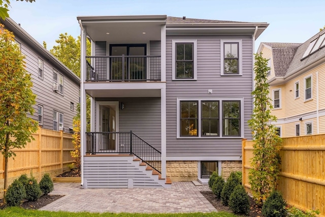 rear view of house with a balcony