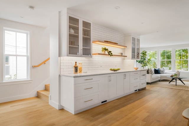 bar with plenty of natural light and white cabinets