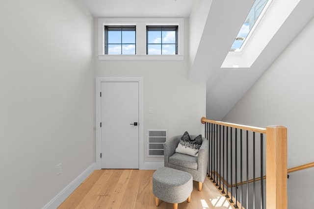 entrance foyer with light hardwood / wood-style floors and a towering ceiling