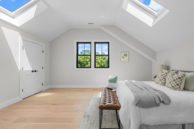 bedroom featuring light hardwood / wood-style floors and lofted ceiling