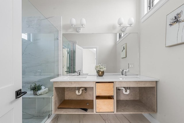 bathroom with a tile shower and vanity