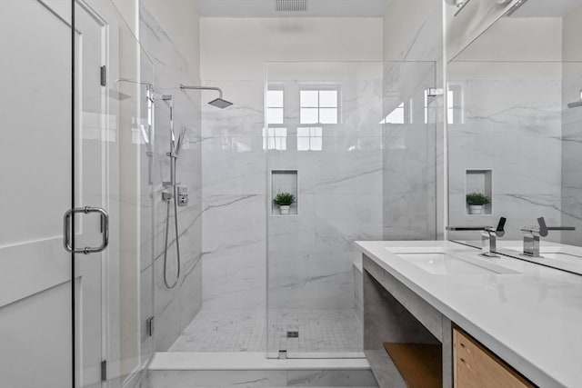 bathroom featuring vanity and an enclosed shower