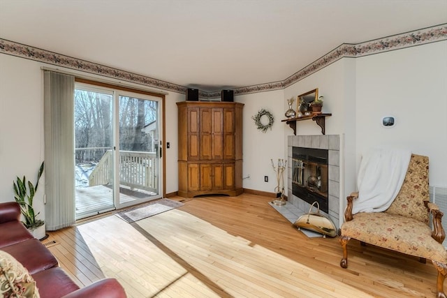 living room featuring light hardwood / wood-style floors and a tile fireplace