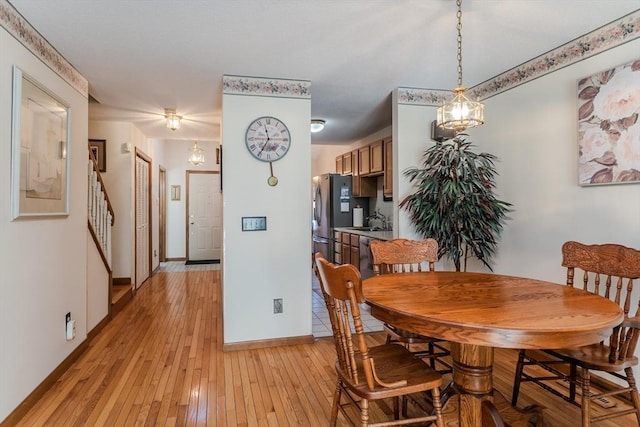 dining area with sink and light wood-type flooring