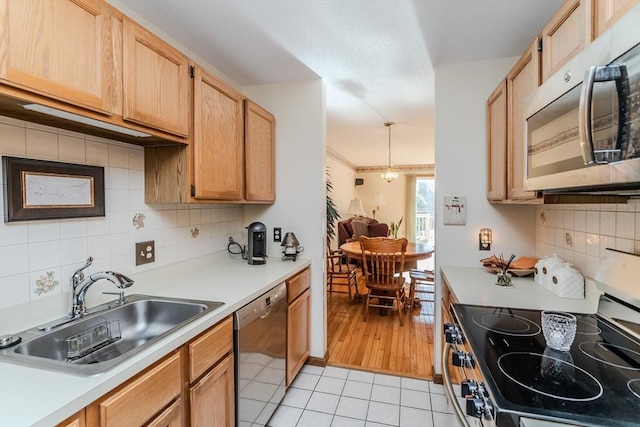 kitchen with appliances with stainless steel finishes, light brown cabinetry, sink, backsplash, and light tile patterned floors