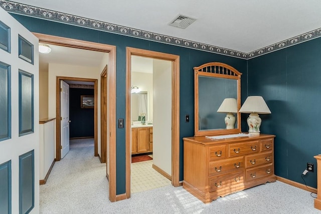 hallway featuring light carpet