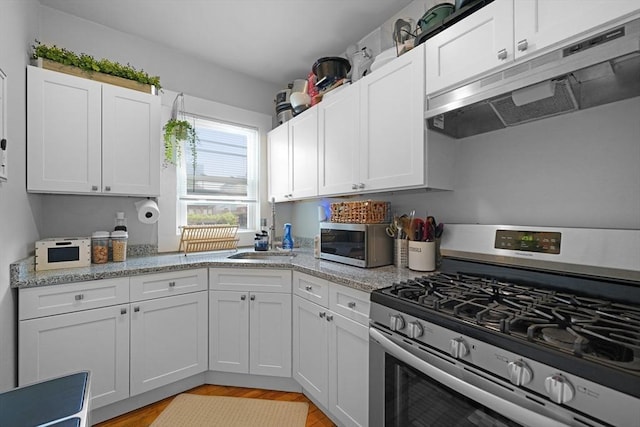 180 Irvington St, New Bedford, MA 02745 - kitchen with appliances with stainless steel finishes, under cabinet range hood, a sink, and white cabinets