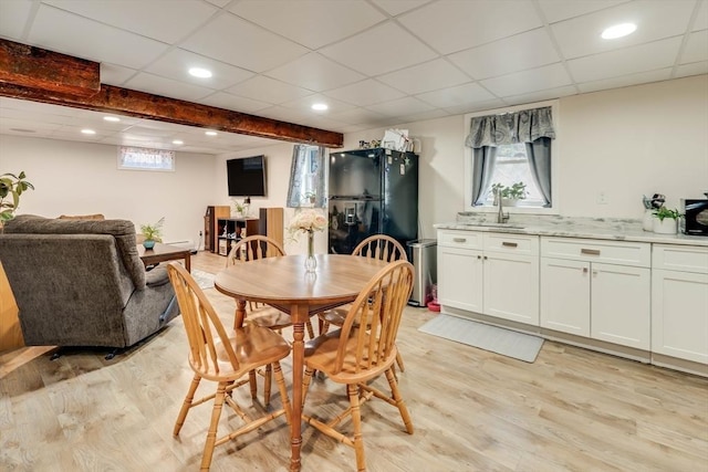 dining room with recessed lighting, a paneled ceiling, light wood-type flooring, and a wealth of natural light