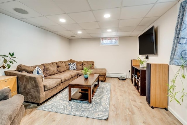 living area with recessed lighting, a baseboard radiator, baseboards, and light wood finished floors