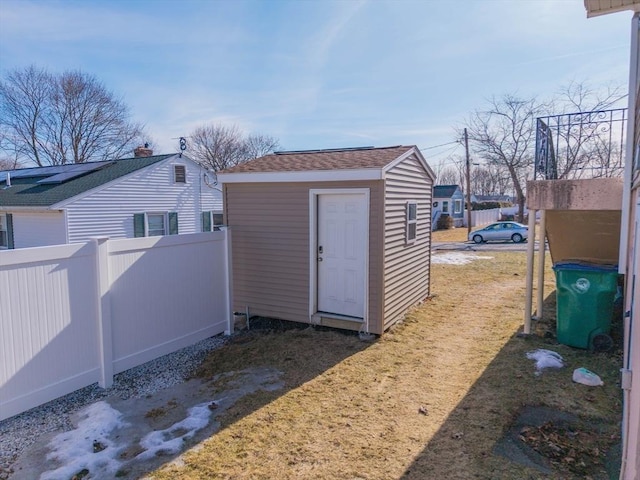 view of outdoor structure featuring an outbuilding and fence