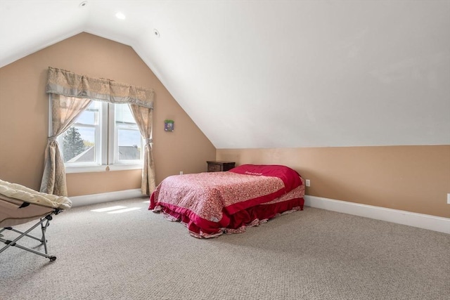 bedroom featuring carpet flooring, baseboards, and vaulted ceiling