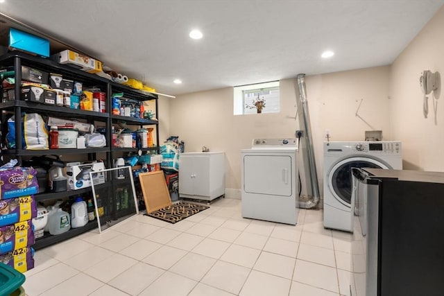 laundry area featuring separate washer and dryer, tile patterned floors, recessed lighting, and laundry area
