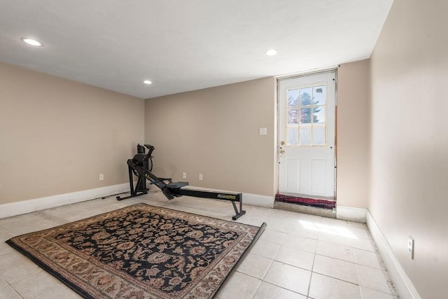 exercise room featuring recessed lighting, baseboards, and light tile patterned floors