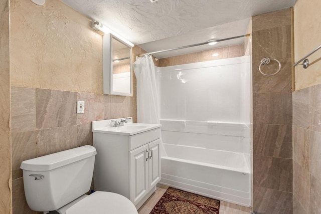 bathroom with vanity, toilet, tile walls, and shower / tub combo with curtain
