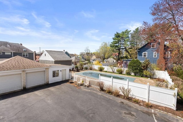 view of swimming pool with fence and a residential view