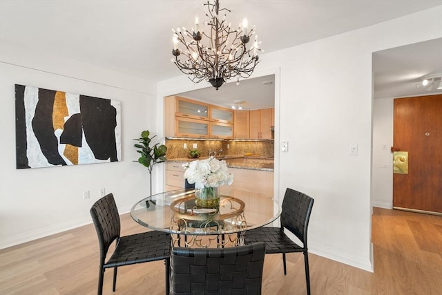 dining area featuring a chandelier and light hardwood / wood-style flooring