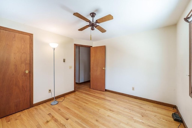 unfurnished bedroom with light wood-style flooring, baseboards, and ceiling fan