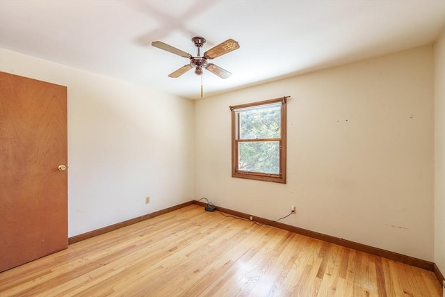 unfurnished room with a ceiling fan, light wood-style flooring, and baseboards