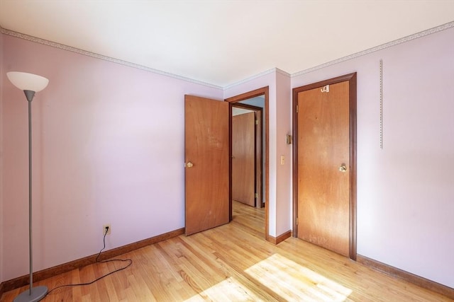 spare room with light wood-type flooring and baseboards