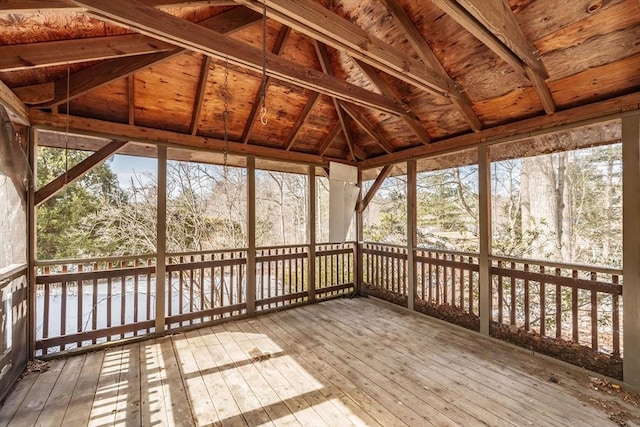 unfurnished sunroom featuring lofted ceiling