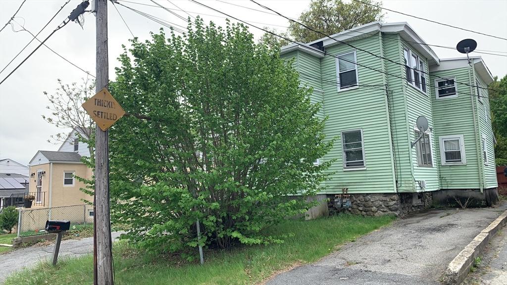 view of side of property featuring fence