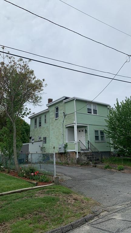 view of front of property with fence, asphalt driveway, and a chimney