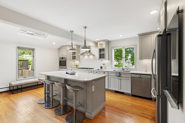 11 Williams St, Arlington, MA 02476 - kitchen with stainless steel appliances, decorative backsplash, healthy amount of natural light, recessed lighting, and vaulted ceiling